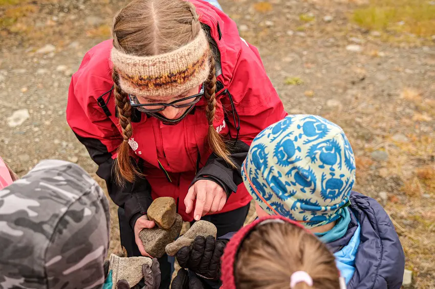 Geology students showing kids the different types of rocks. 